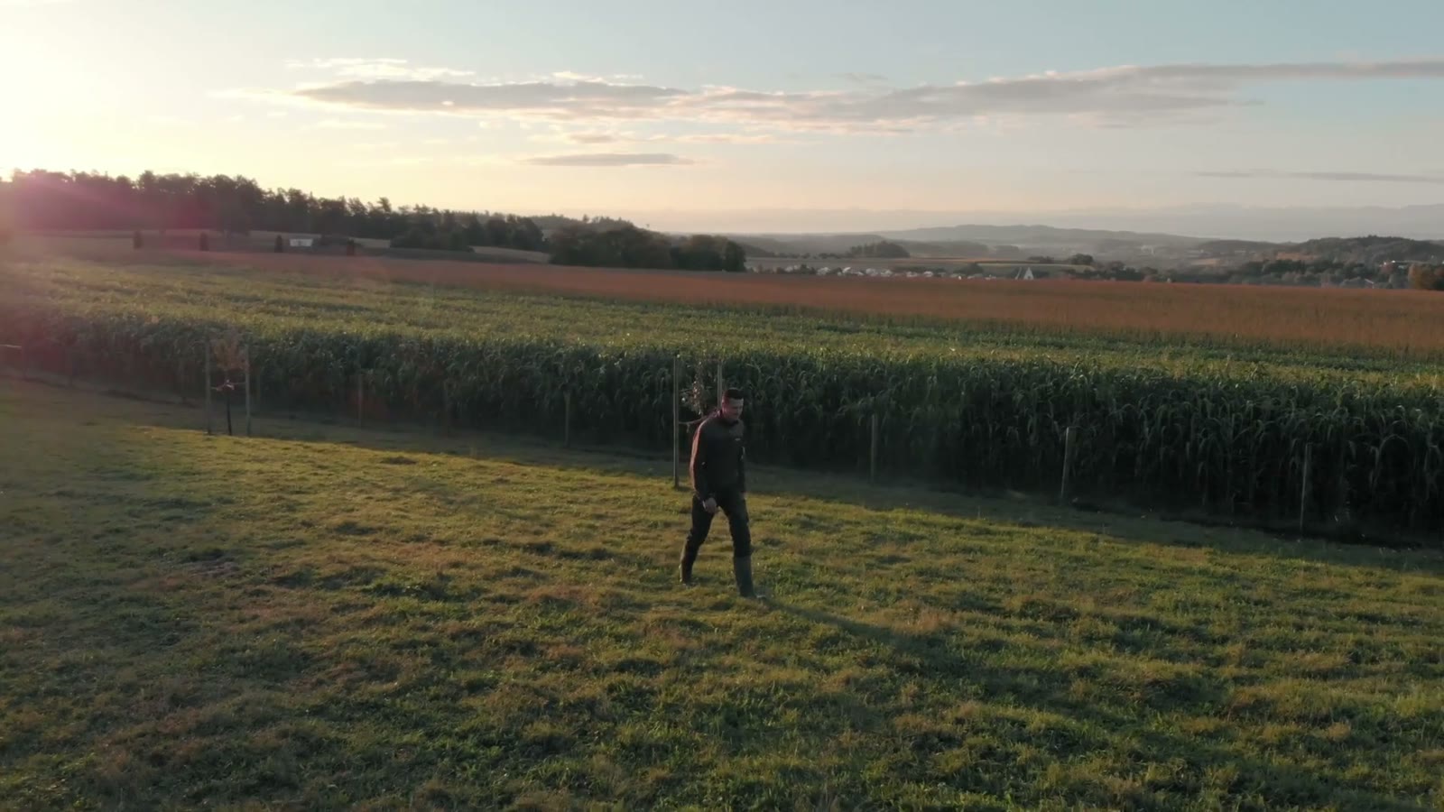 Simon Martin läuft bei Abendsonne über eine Wiese am Feldrand